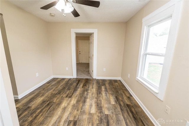 spare room featuring dark hardwood / wood-style floors and a textured ceiling