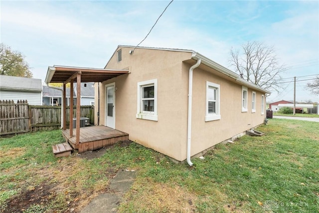 rear view of property with a lawn