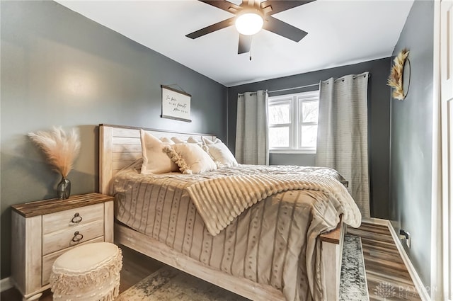 bedroom with dark wood-type flooring and ceiling fan