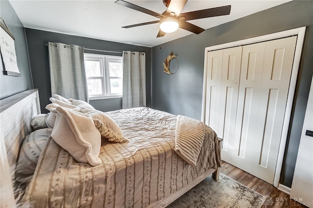 bedroom with hardwood / wood-style flooring, ceiling fan, and a closet