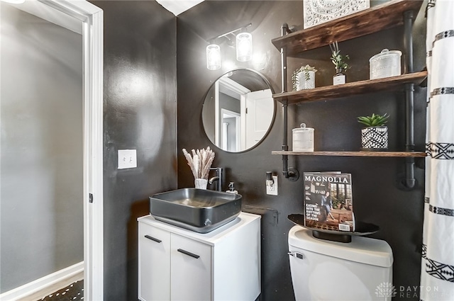 bathroom featuring toilet and vanity