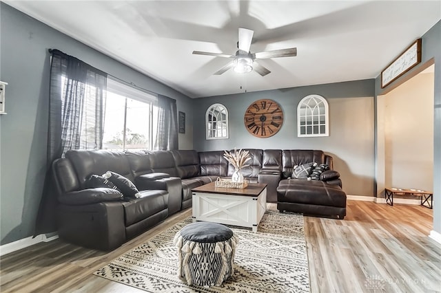 living room featuring hardwood / wood-style floors and ceiling fan