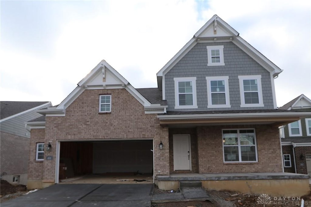 view of front of property with covered porch and a garage