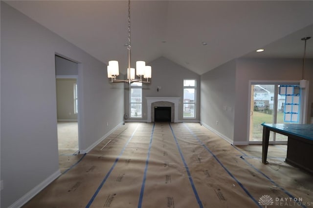 unfurnished living room with vaulted ceiling and a notable chandelier