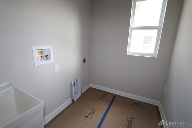 laundry area with hookup for an electric dryer, sink, and hookup for a washing machine