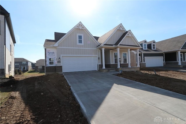 craftsman inspired home featuring a porch, driveway, board and batten siding, and brick siding