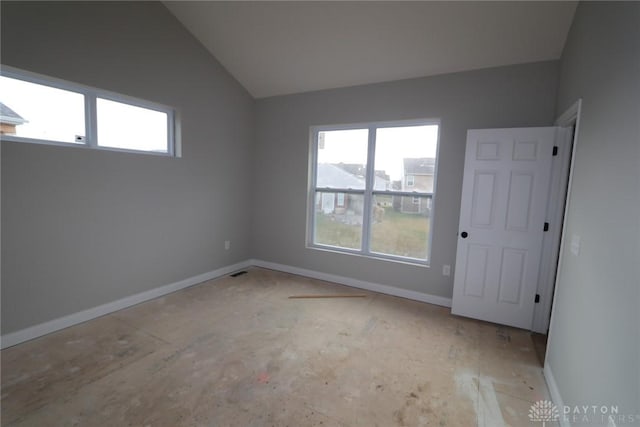 unfurnished room with lofted ceiling