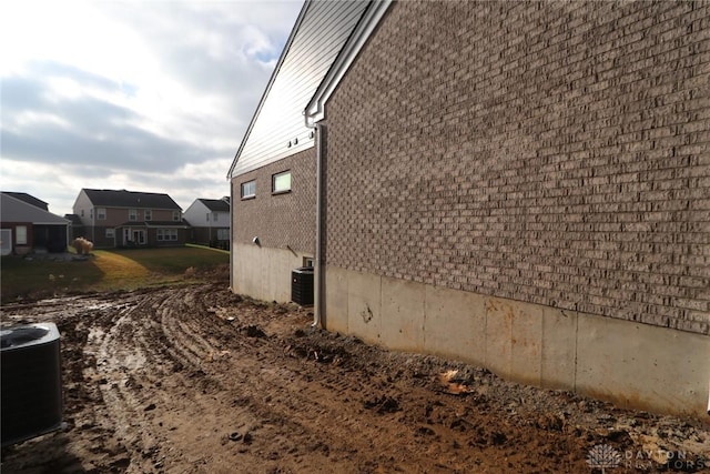 view of property exterior with central AC