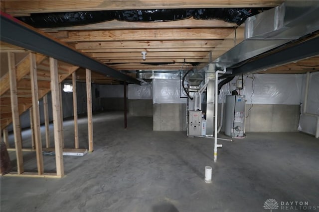 basement featuring gas water heater and heating unit