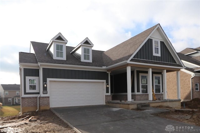 view of front of home with a porch and a garage