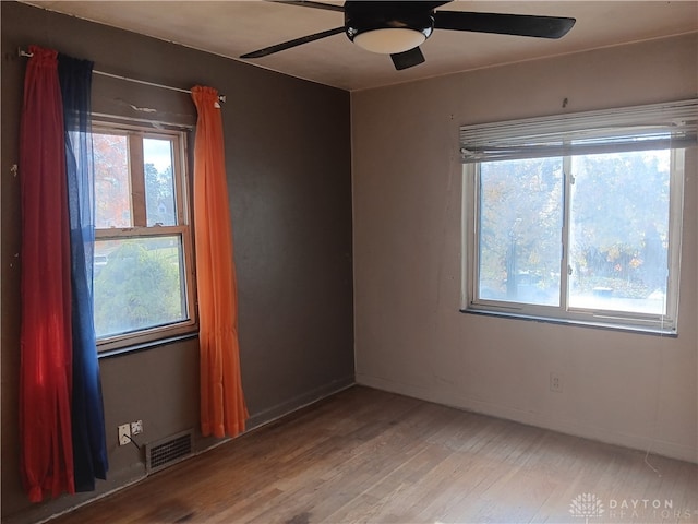 unfurnished room with wood-type flooring and ceiling fan