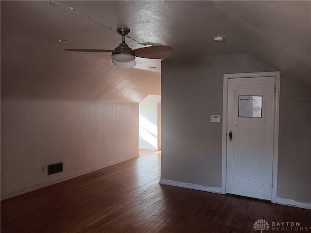 bonus room featuring ceiling fan, lofted ceiling, a textured ceiling, and dark hardwood / wood-style floors