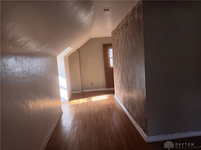 bonus room featuring wood-type flooring and vaulted ceiling