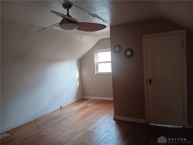 additional living space with vaulted ceiling, ceiling fan, and light hardwood / wood-style flooring