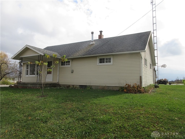 rear view of house with a yard