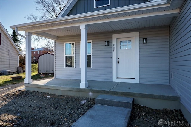 property entrance featuring covered porch and central AC unit