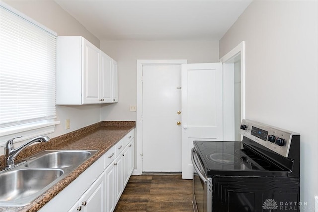 kitchen featuring sink, white cabinetry, dark hardwood / wood-style floors, and stainless steel range with electric stovetop