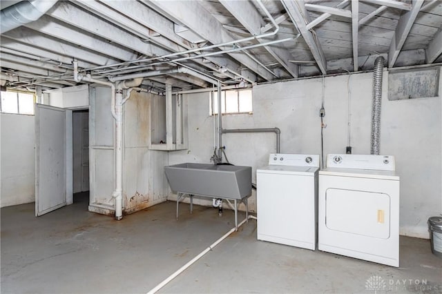 basement featuring sink and independent washer and dryer