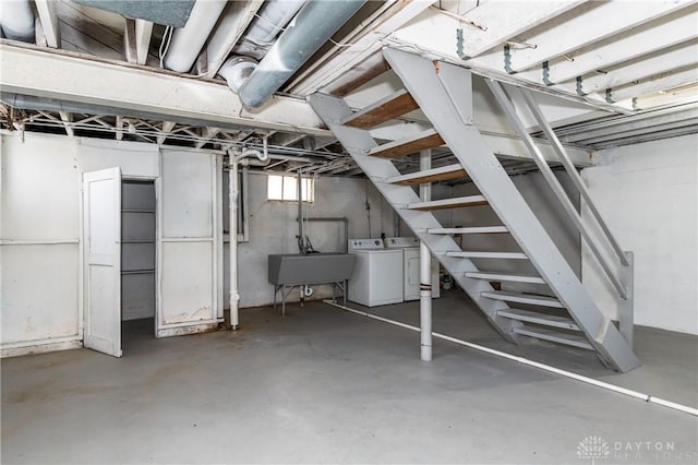 basement with washer and clothes dryer and sink