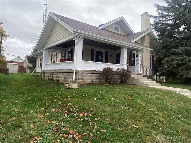 view of front facade featuring a front lawn and covered porch