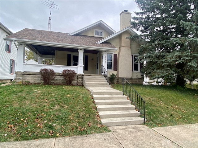 view of front of property with a porch and a front yard