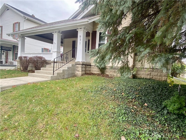 view of front of home featuring a front yard and a porch