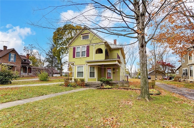 victorian home with a front lawn and covered porch