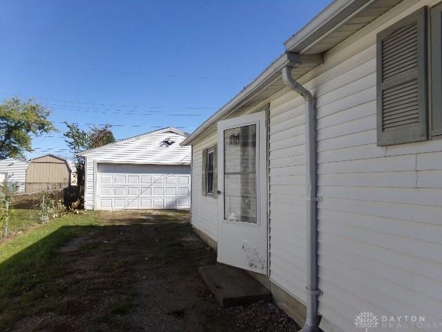 view of side of property featuring an outdoor structure and a garage