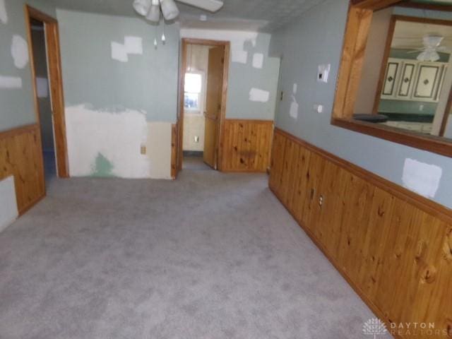 unfurnished room with ceiling fan and light carpet