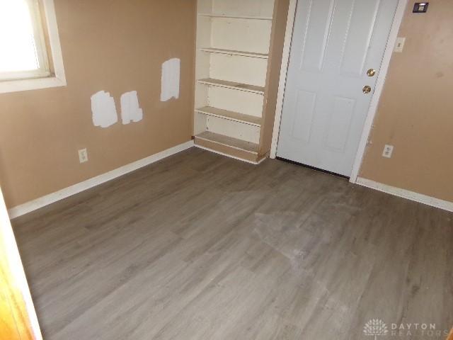 unfurnished bedroom with dark hardwood / wood-style flooring and a closet