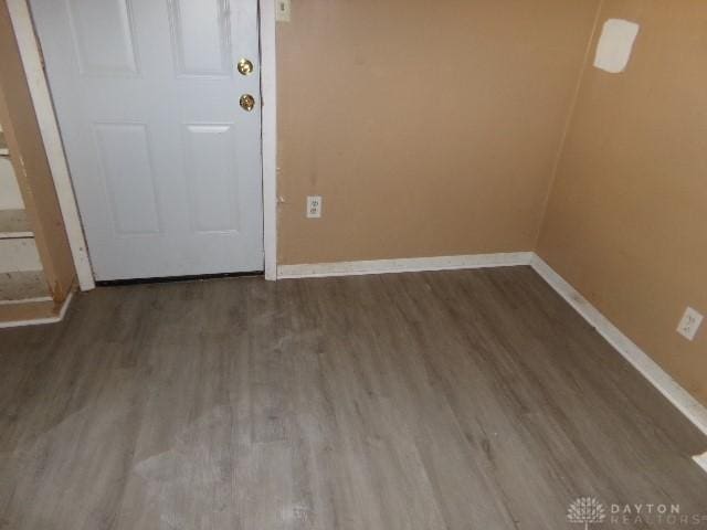 spare room featuring wood-type flooring