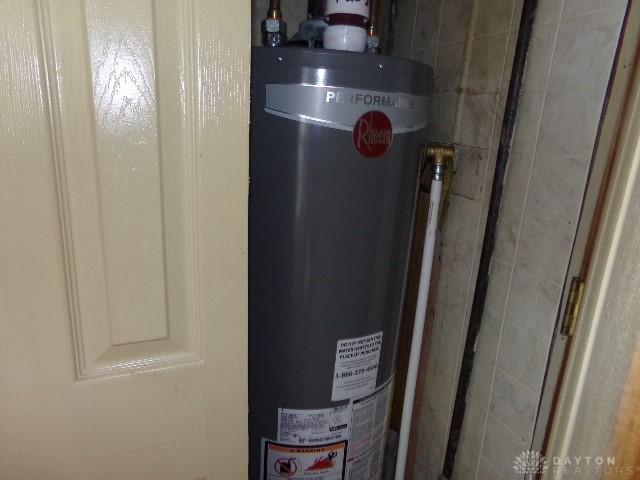 utility room featuring gas water heater