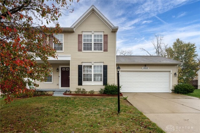 view of front of home featuring a garage and a front yard