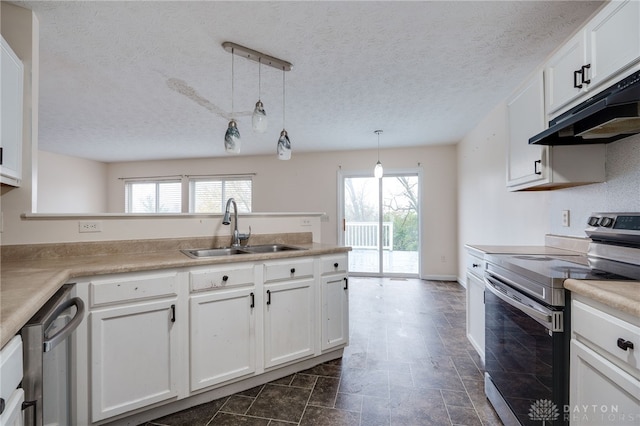 kitchen featuring appliances with stainless steel finishes, a sink, white cabinetry, and under cabinet range hood