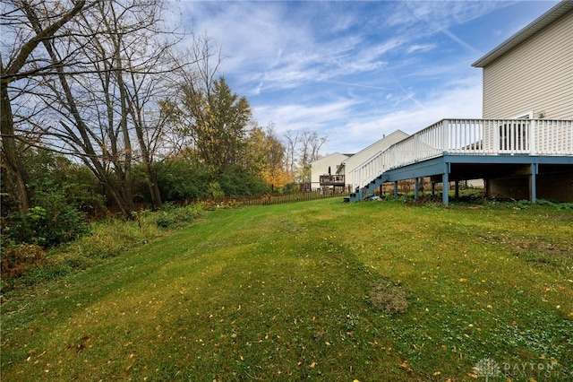 view of yard featuring fence, stairway, and a wooden deck