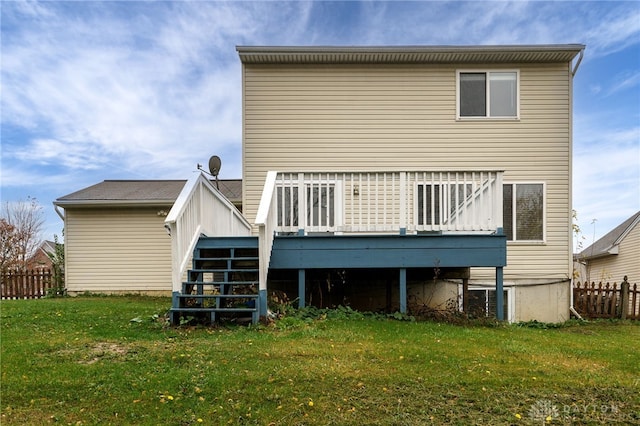 back of house with stairs, a lawn, fence, and a wooden deck