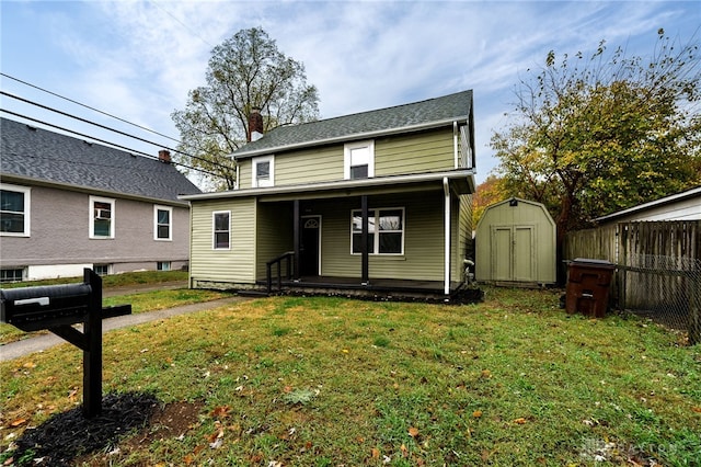 view of front of property featuring a storage unit and a front yard