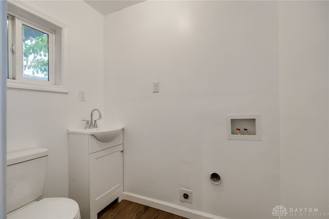 bathroom with vanity, toilet, and wood-type flooring