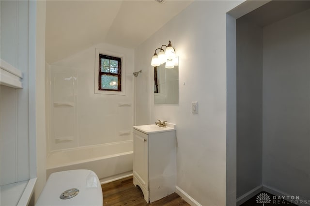 bathroom featuring wood-type flooring, vanity, shower / tub combination, and vaulted ceiling