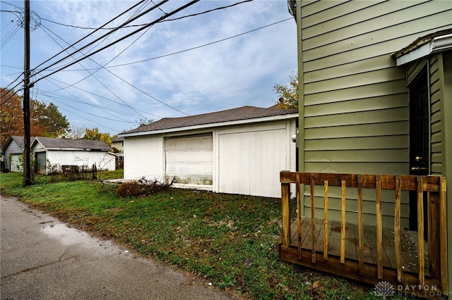 view of side of home with a garage and an outdoor structure