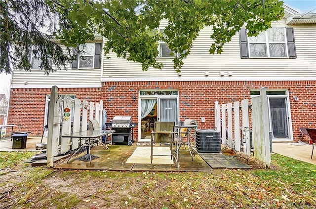 rear view of property featuring a patio and central air condition unit