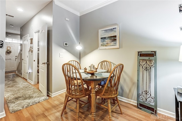 dining room featuring hardwood / wood-style floors and ornamental molding