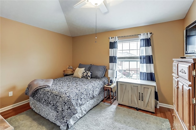 bedroom featuring hardwood / wood-style flooring, ceiling fan, and vaulted ceiling