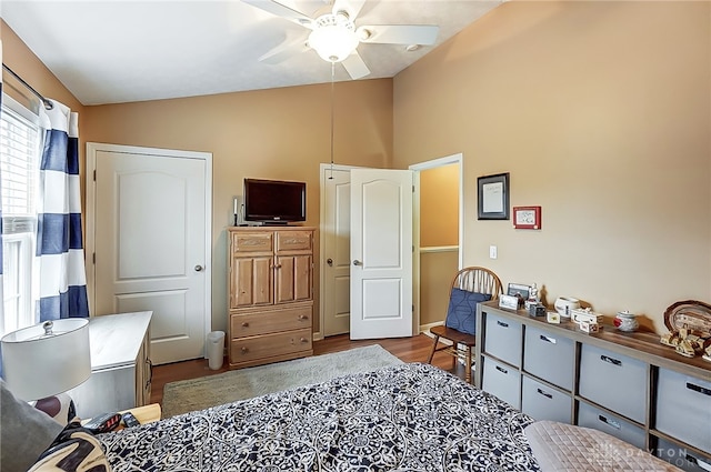 bedroom featuring hardwood / wood-style flooring, ceiling fan, and lofted ceiling