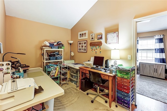 office featuring lofted ceiling and light carpet