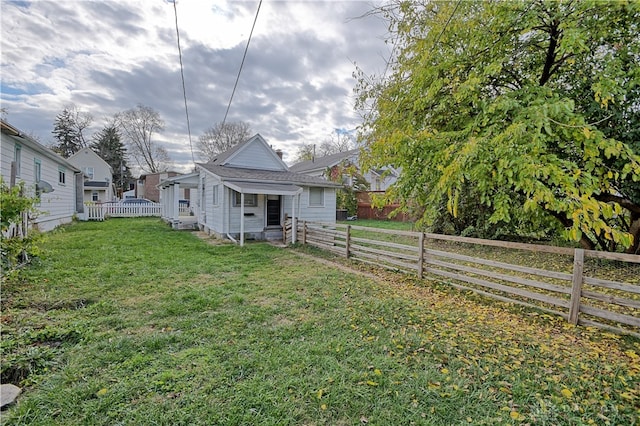 back of house with a lawn