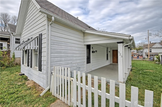 view of side of home featuring a lawn