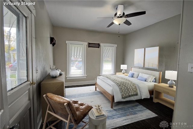 bedroom with wood-type flooring and ceiling fan