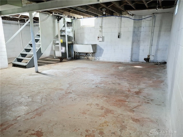 basement featuring heating unit and sink