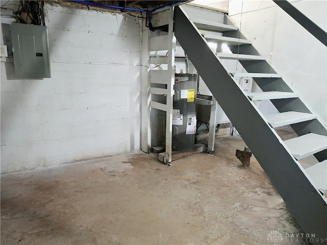 basement featuring electric panel and water heater